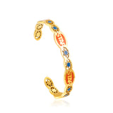 Hard bangle with many colors on the surface with drops of oil and shells in open gold color