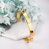 Gold hard bracelet with three different colors and diamonds