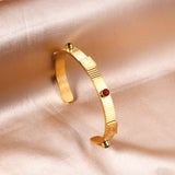 Gold hard bracelet with three different colors and diamonds