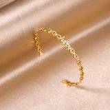 Happy monogrammed gold colored hard bracelet