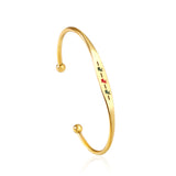 Hard bracelet with oil-drip pattern on gold-colored surface