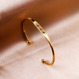 Hard bracelet with oil-drip pattern on gold-colored surface