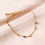 Bracelet 3 globes oculaires bleus + 7 perles acier 18+3cm