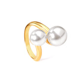 Two large and two small pearls in open pearl setting ring