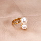 Two large and two small pearls in open pearl setting ring