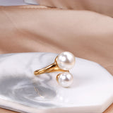 Two large and two small pearls in open pearl setting ring