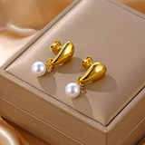 Minimalist smooth grain stud earrings with a pearl.