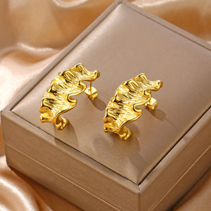 C-shaped earrings with cast rolled edges and irregularly shaped surfaces