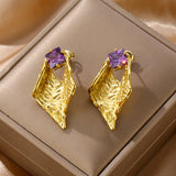 Extremely personalized earring shapes with a purple diamond.