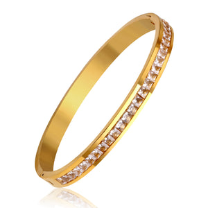 Gold-tone hard bracelet with a circle of diamonds in the center