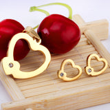 Set of cut jewelry in the shape of a heart x 2 + a small heart with diamonds on the upper door in gold/steel-colored wisps with a glossy finish