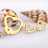 Set of cut jewelry in the shape of a heart x 2 + a small heart with diamonds on the upper door in gold/steel-colored wisps with a glossy finish