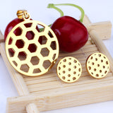 Gold/steel football-like discs with a hollowed-out center, faceted cut jewelry set with no diamonds.