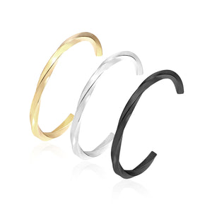 Three colors of black gold-tone steel with a rotating surface on an open-end rigid bracelet.