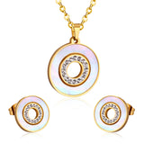 Gold/steel color white shells set with diamonds on top of circle with diamonds jewelry set