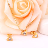 Gold/steel triangle jewelry set with diamond in the center