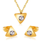 Gold/steel triangle jewelry set with diamond in the center