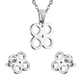 Gold/steel cut jewelry set with four regular round faceted center wisps without diamonds