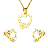 Set of cut jewelry in the shape of a heart x 2 + a small heart with diamonds on the upper door in gold/steel-colored wisps with a glossy finish