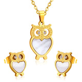 Gold/steel owl with diamonds on surface + shells glued on body jewelry set