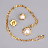 Gold/steel half pearl standing on top of round cake jewelry set